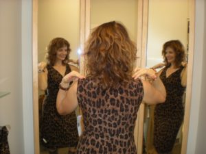 Woman in leopard dress in changeroom